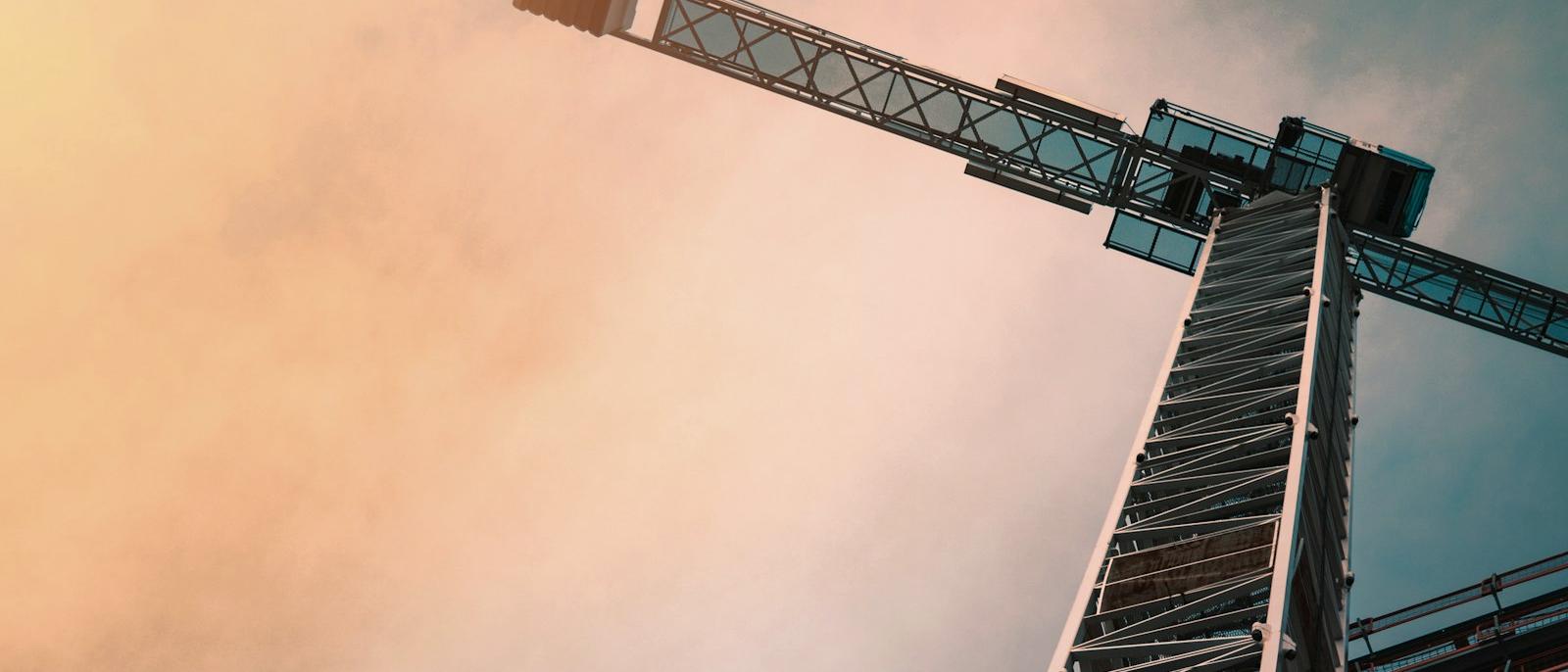 Tower crane photographed from below against an open sky