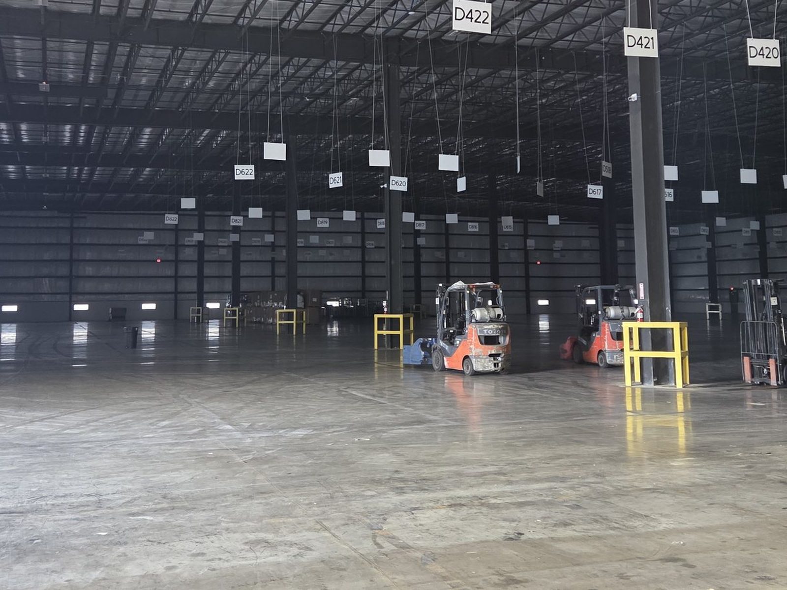 Dock-high warehouse floor at the Tetrad Laredo facility with forklifts and numbered dock positions
