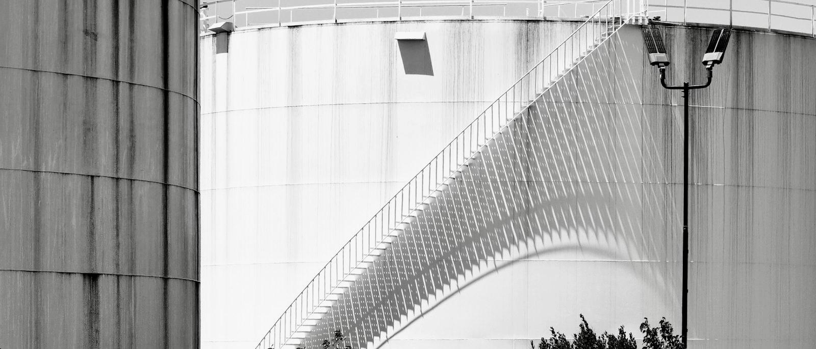 Storage tanks photographed in high-contrast monochrome